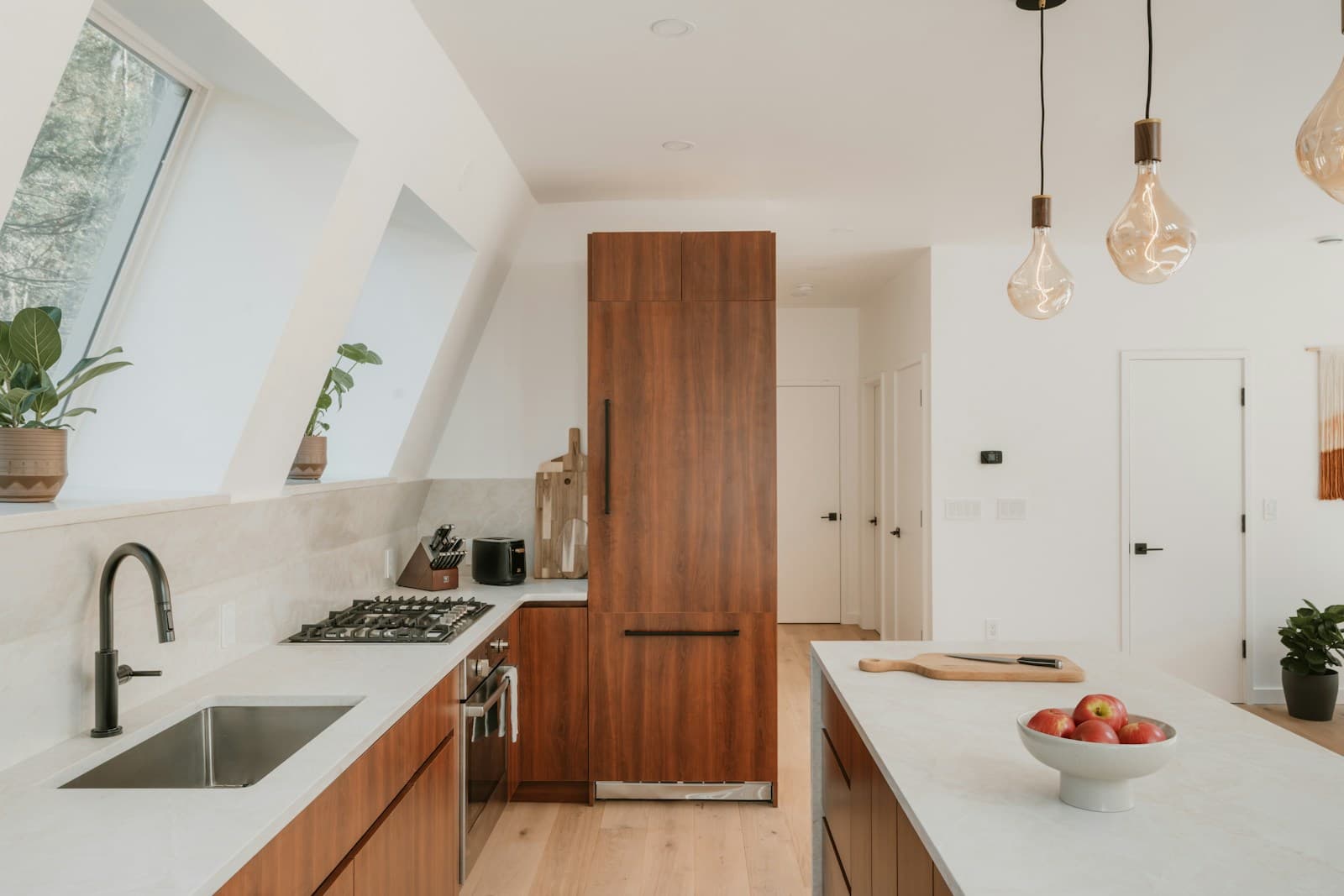 Completed open-plan kitchen with timber cabinetry after full renovation