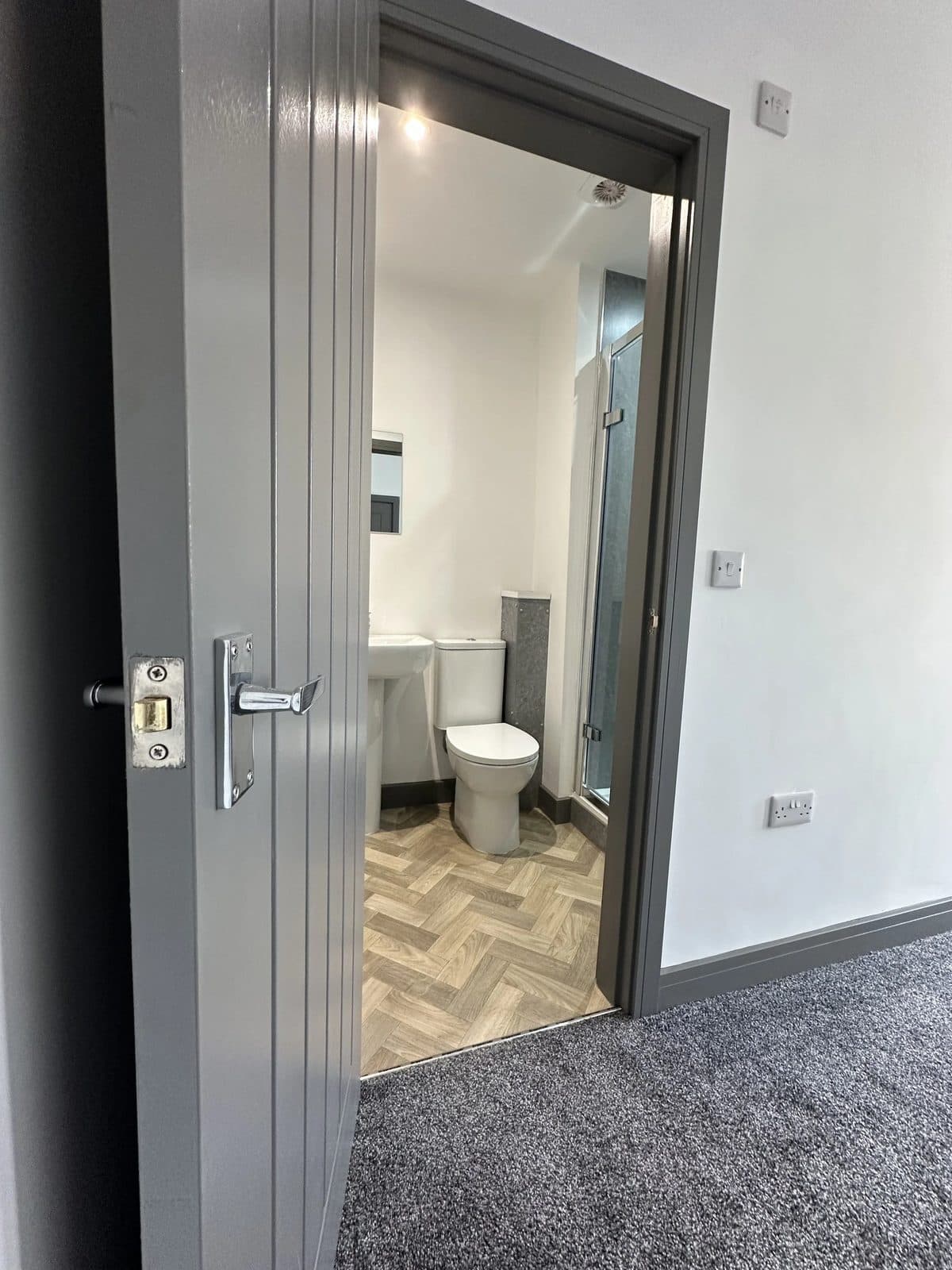 Bedroom with built-in storage and en-suite door