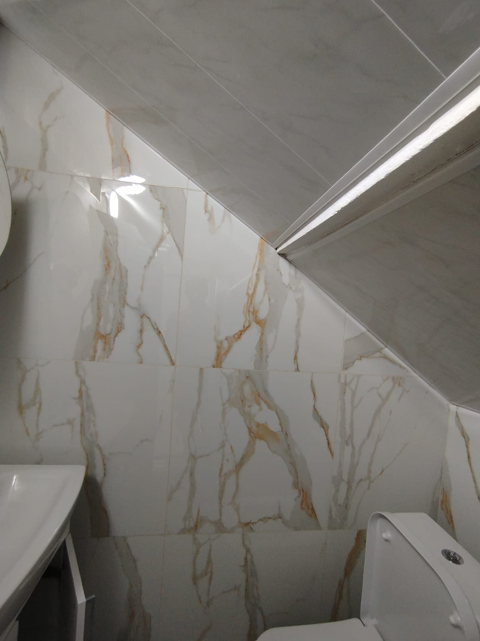 Detail of marble tiling around the bathroom door and corner