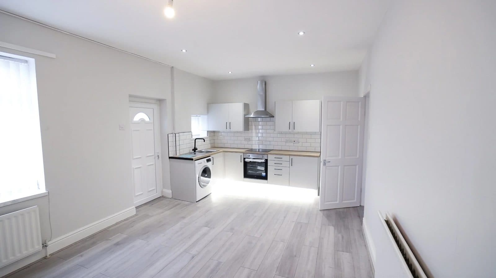 Kitchen with neutral cabinetry and stone-effect worktop