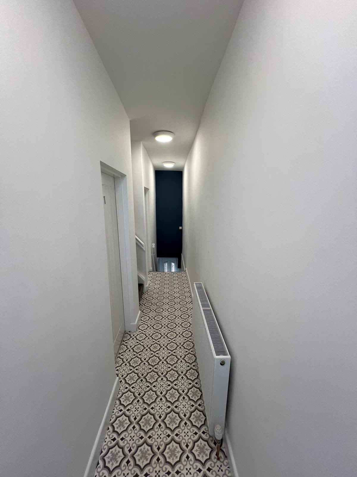 Patterned tile hallway running through the property