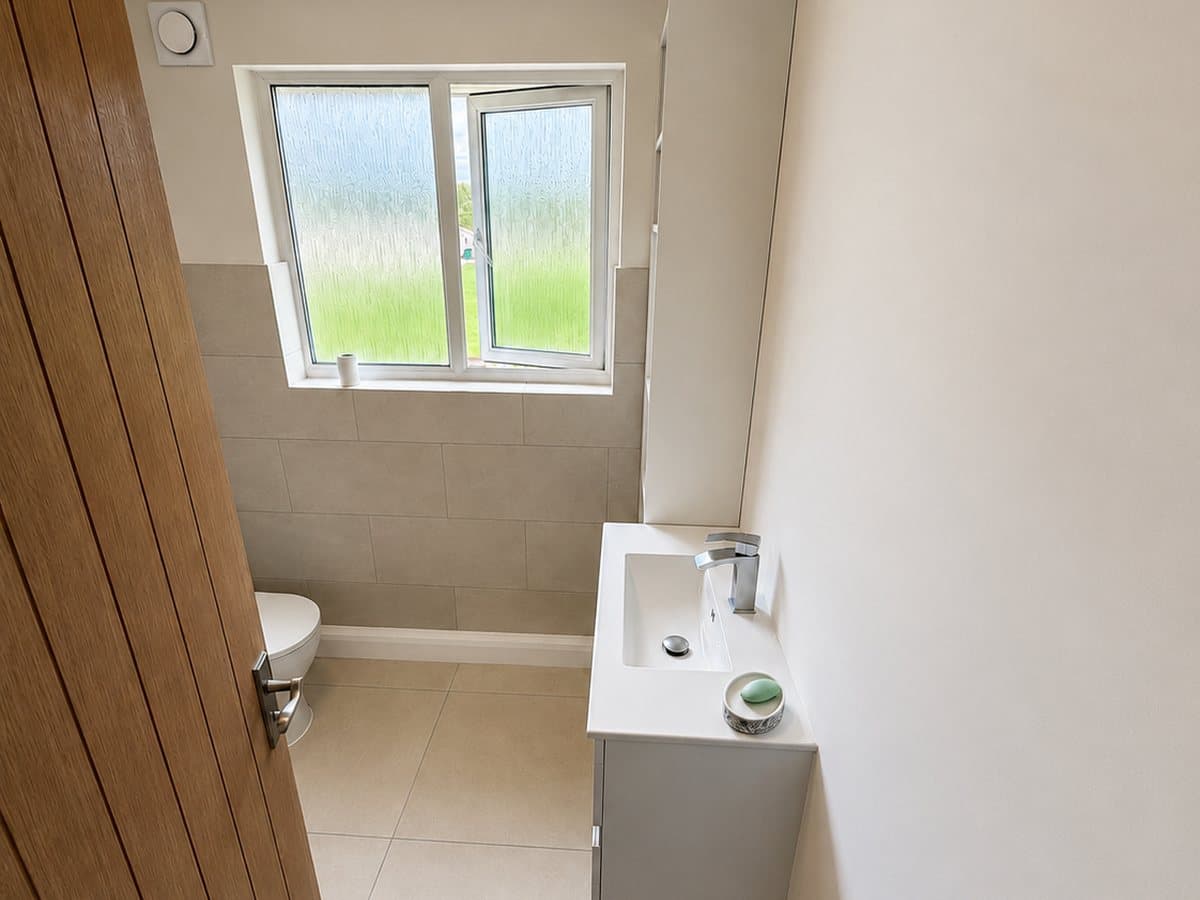 WC and slim basin beside the solid oak bathroom door