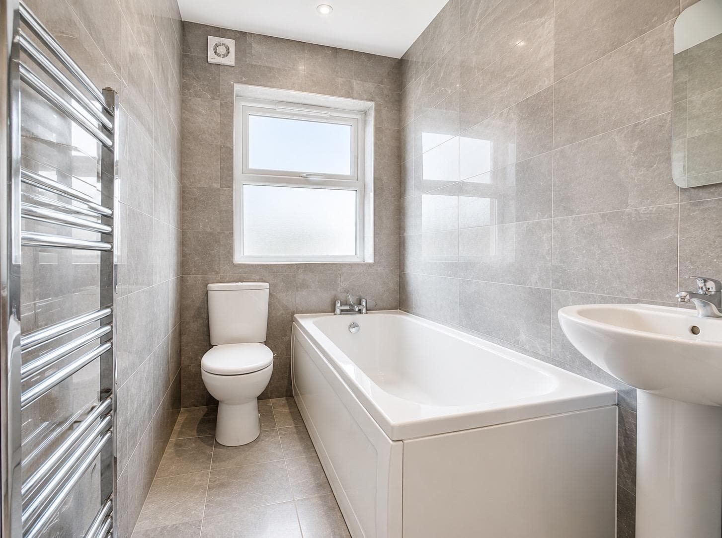 Family bathroom with bath, WC, pedestal basin and chrome heated towel rail